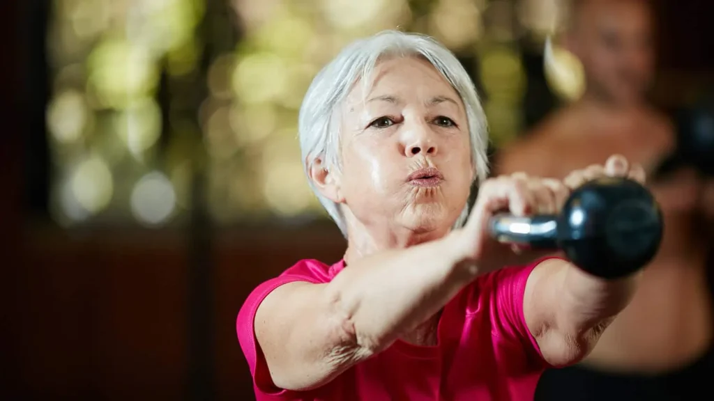 Toning Arms Without the Bulk: Is It Achievable? 1 Woman doing resistance band exercises for toned arms Ayr