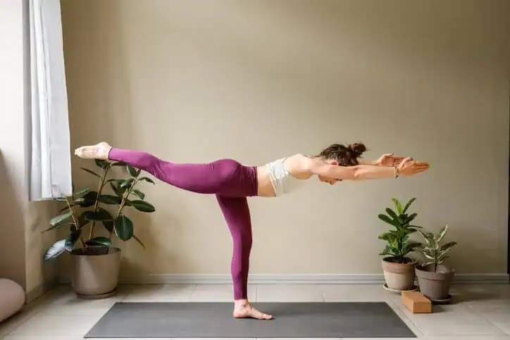 Woman doing Yoga exercise Ayr to help with toning the body. 